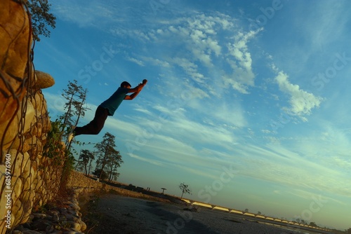 man jumping from the embarkment in the aie in assam