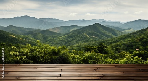 Expansive Wooden Deck Overlooking Layers of Lush Green Mountains Under a Hazy Sky
