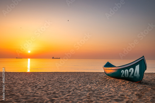 2024 New year concept Fishing Boat on Varna beach shore on sunrise