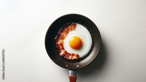 Fried egg and bacon in a pan
