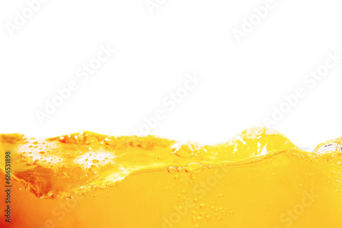 Orange juice with bubbles isolated on a white background. Close-up.