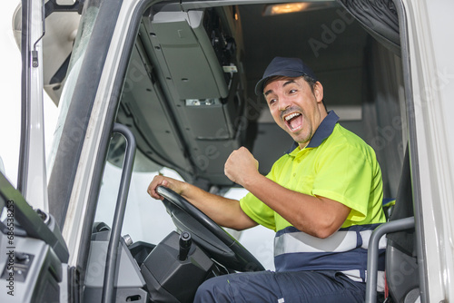 Cheerful male driver opening mouth in excitement while driving truck