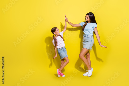Photo of successful teen kid girls team win in school contest give high five isolated over bright color background