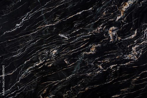 Dark granite slack with light and yellow veins, large format texture,
