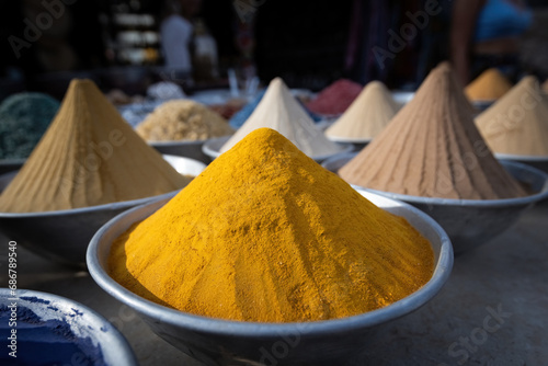 Pyramids of spices and color powder on Egyptian market in Aswan Egypt