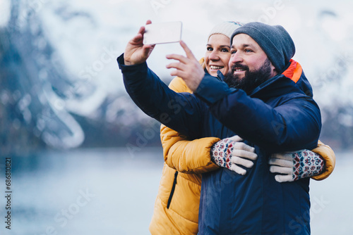 Tourist couple taking a selfie at Hamnoy, Lofoten, Norway