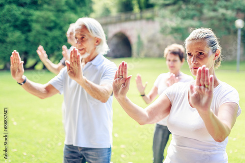 Group of seniors doing Tai chi in a park