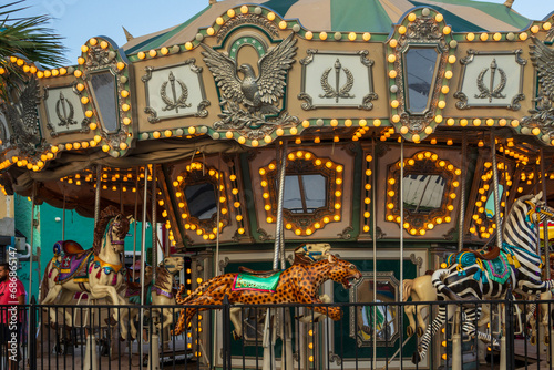 A Merry-go-round with horses and cheetahs with colorful lights and carnival rides along the boardwalk at the Carolina Beach Boardwalk in Carolina Beach North Carolina USA