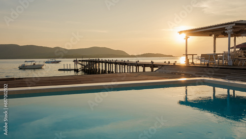 swimming pool and wooden pier in the ocean during sunset in Samaesan Thailand.