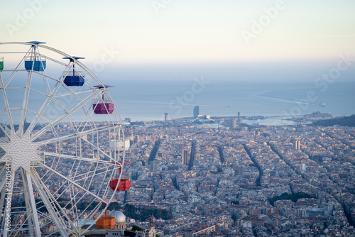 Ferris Wheel in Tibidabo Barcelona city from the top with city and sea on background
