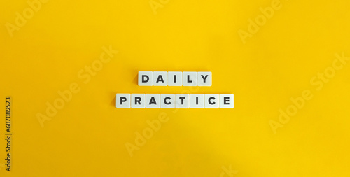 Daily Practice Text on Block Letter Tiles on Yellow Background. Minimalist Aesthetics. Strong Word Ethic, Commitment, and Self-discipline Concept.