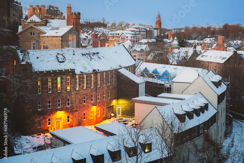 Quaint and historic Dean Village covered in snow along the Water of Leith during a winter twilight in Edinburgh, Scotland, UK.