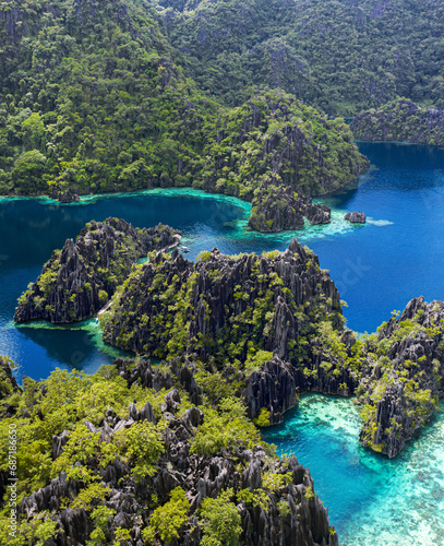 aerial photography of paradisiacal islands of indonesia, philippines tropical vacations with blue water and green jungle