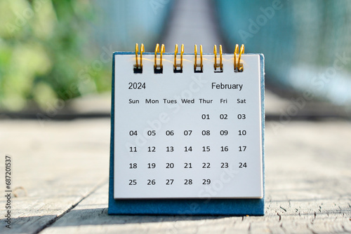 February 2024 white calendar with green blurred background. New year concept.
