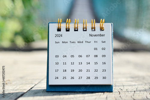 November 2024 white calendar with green blurred background. New year concept.