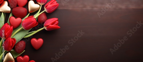 Valentine s Day themed with chocolates hearts and red tulips Copy space image Place for adding text or design