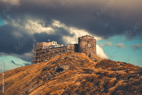 Pip Ivan mount Observatory at the top of mountain, Carpathian, Ukraine. Dramatic picturesque scenery, Cloudy sky, autumn orange grass. Popular touristic destination. Travel, tourism, trekking, hiking