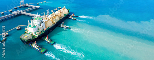 LNG (Liquefied natural gas) tanker anchored in Gas terminal gas tanks for storage. Oil Crude Gas Tanker Ship. LPG at Tanker Bay Petroleum Chemical or Methane freighter export import transportation.