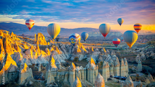 Amazing panoramic view of sunrise Cappadocia landscape with colorful hot air balloons in the love valley- Travel destination concept Turkey