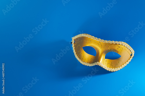 Carnival mask on blue background, a theatrical piece, cabaret show