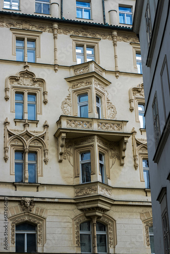 An old house in the Victorian style. The plasterwork on the house is quite old. The warm color emphasizes mystery and memories from past generations.