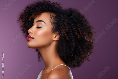 A woman with curly hair has her eyes closed