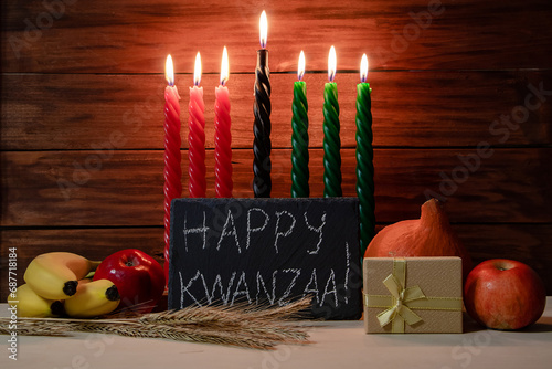 Kwanzaa African American holiday. Seven candles on wooden background.