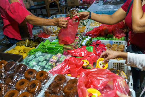 Many varieties of traditional snacks sold in the Marketplace in dawn time in Surabaya, East Java, Indonesia.