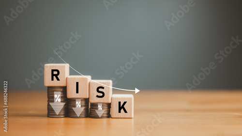 business, finance, low risk investment, Risk Management, Risk wording on decreasing coins stacking with down arrow for financial banking risk analysis and management ,Low risk low return concept.