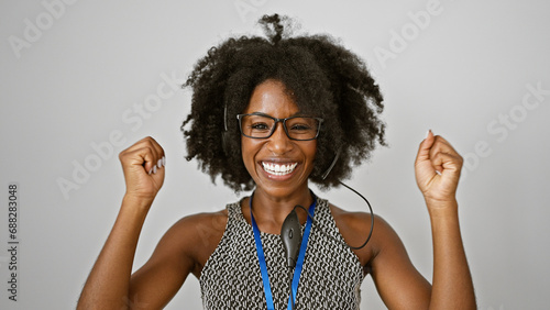 African american woman business worker wearing headset celebrating over isolated white background