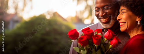 Senior couple celebrating Valentine's Day with love and roses. Shallow field of view. 
