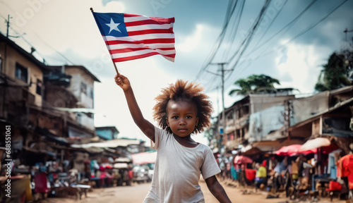 Liberian girl holding Liberia flag in Monrovia street