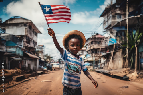 Liberian boy holding Liberia flag in Monrovia street