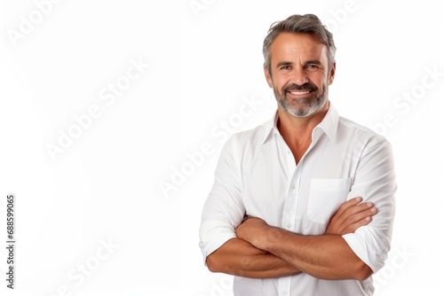 Smiling middle-aged man with folded arms and a deadpan expression posing in front of a white background with copy space