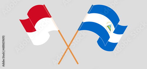 Crossed and waving flags of Monaco and Nicaragua.