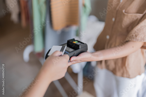 Contactless payment holding credit card with touch settlement paying for shopping nfc technology transaction cashless technology and credit card payment
