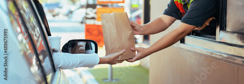 Woman getting fast food at drive-thru