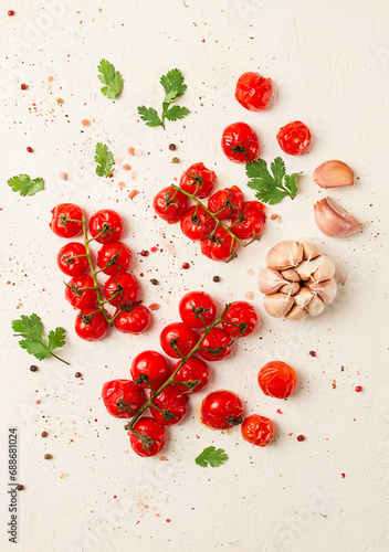 branch with mini cherry tomatoes, with spices and herbs, garlic, food background, top view, on a white background,