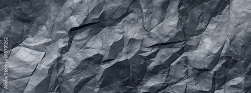 A dark blue rock face, surface background with jagged edges and crevices. 