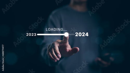 Man hand touching loading bar for countdown to 2024. In progress loading year 2023 to 2024, Planning and challenge business strategy in new year, Countdown merry Christmas and Happy New Year, Startup,