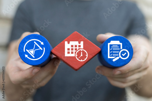 Man holding multi-colored blocks sees icon symbolizing time: calendare with clock. Time management concept planning, organization, working time. Time organization efficiency. Good business process.