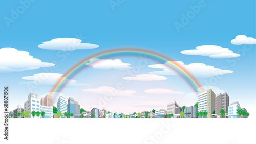虹がかかった空と街並みのイラスト.