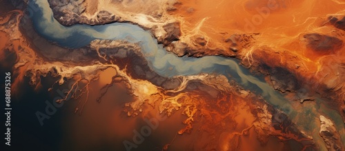 Contaminated rivers and orange soil pollution from industrial activity, as seen from above.