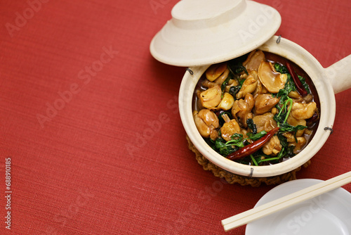 Taiwanese three-cup chicken ( San Bei Ji ) in a clay pot. copy space