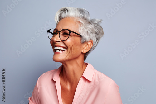 Happily smiling Matured woman side close up portrait view with wrinkles and wearing specs isolated on minimalist copy space background. beautiful smiling woman with good health and skin care concept