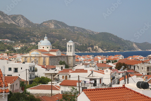 A view of the rooftops of houses and the Church of St. Nicholas in the Greek village of Kokkari on the island of Samos.