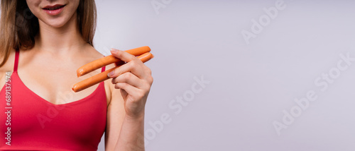 Woman opened her mouth and wants to bite off the sausage, close-up