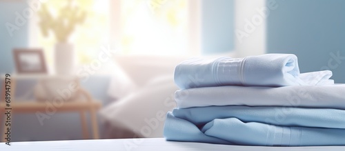 Clean bedding sheets stacked in a blurry laundry room backdrop Copy space image Place for adding text or design