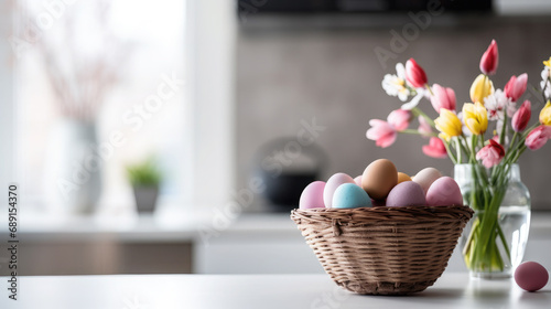 basket with multi-colored Easter eggs on the table in a stylish kitchen, minimalism, Scandinavian interior, postcard, spring, design, religious holiday, traditional dish, treat, decor, flowers