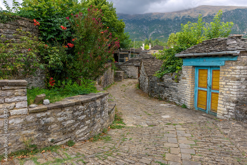 Τraditional architecture with a narrow street and stone buildings in the picturesque village of papigo , zagori Greece